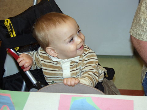 Jack looks on as big sister entertains the Grandmas and Grandpas